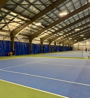 Indoor tennis courts at The Tennis Centre, showing how to start playing tennis as an adult with proper training.