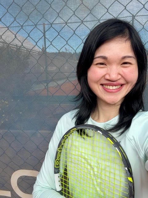 Waepril Chua, the founder of The Modern Serve, holding a tennis racquet.